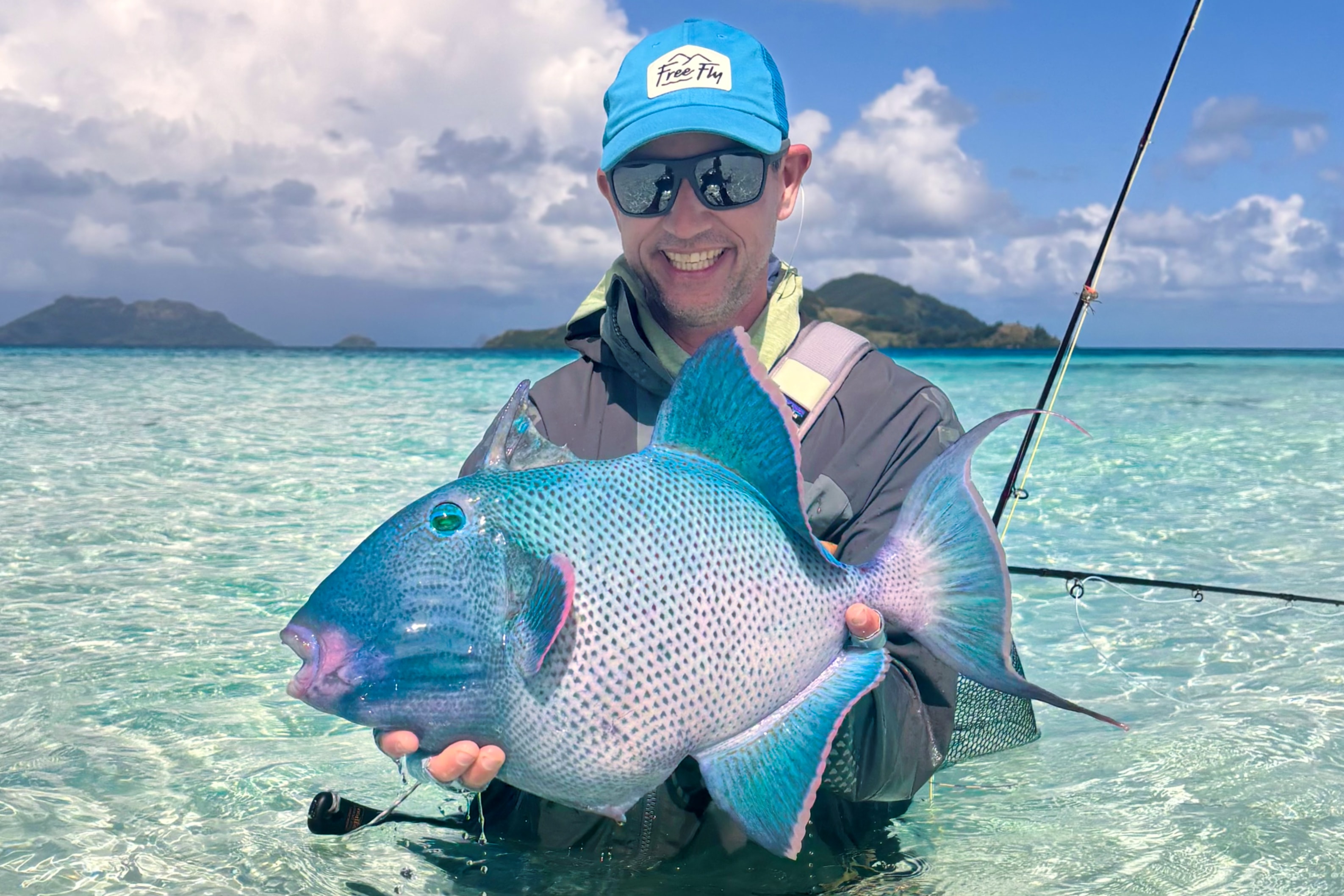Chris Newsome holding blue triggerfish - French Polynesia