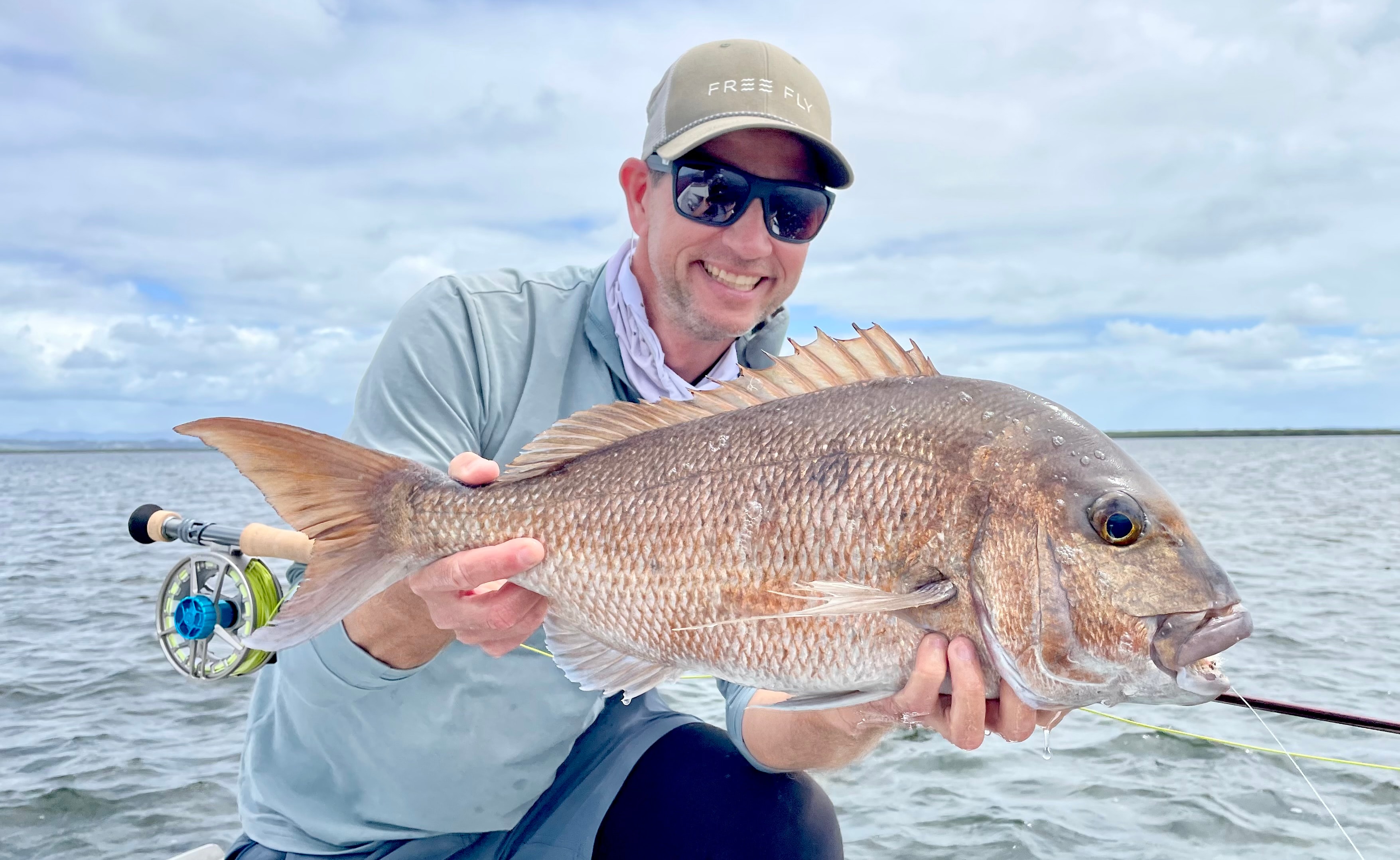 Chris Newsome holding snapper on fly rod