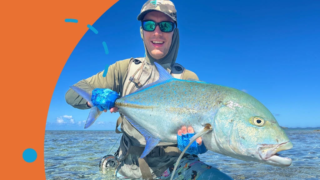 Giant Trevally on Fly — angler holding a trophy GT on the flats of French Polynesia