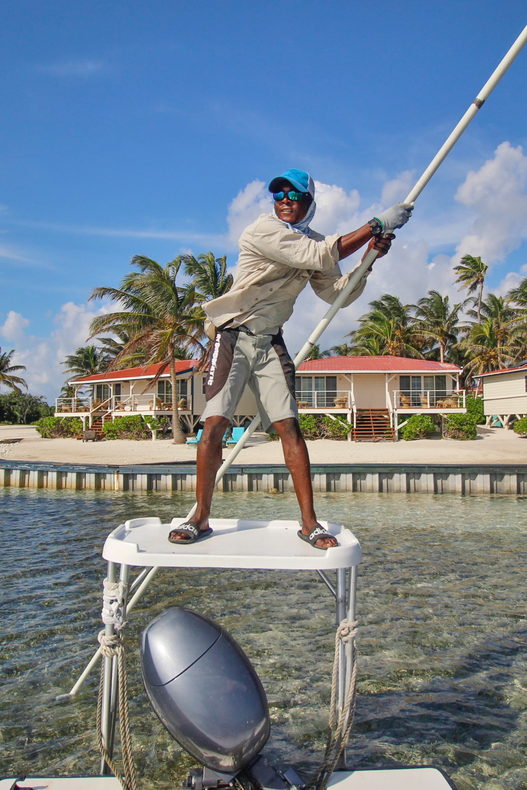 Fishing guide poling skiff tropical flats